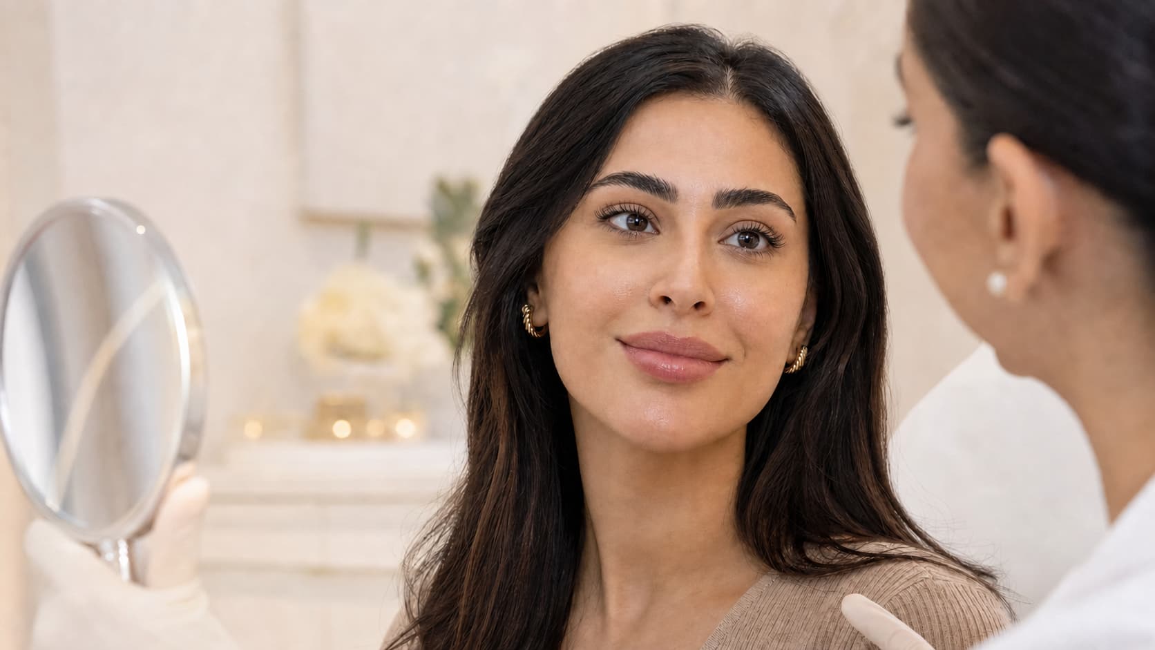 Woman reviewing natural-looking lip filler results during a consultation in Dubai