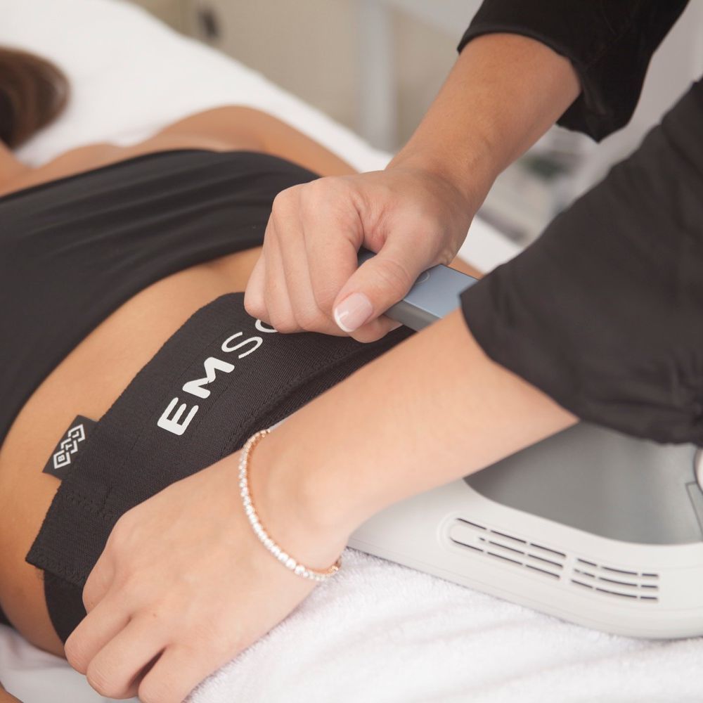 Woman receiving Emsculpt Neo after GLP-1 weight loss at Roxana Aesthetics Clinic
